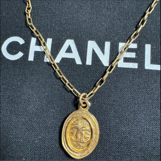 CHANEL gold toned CC logo charm and necklace