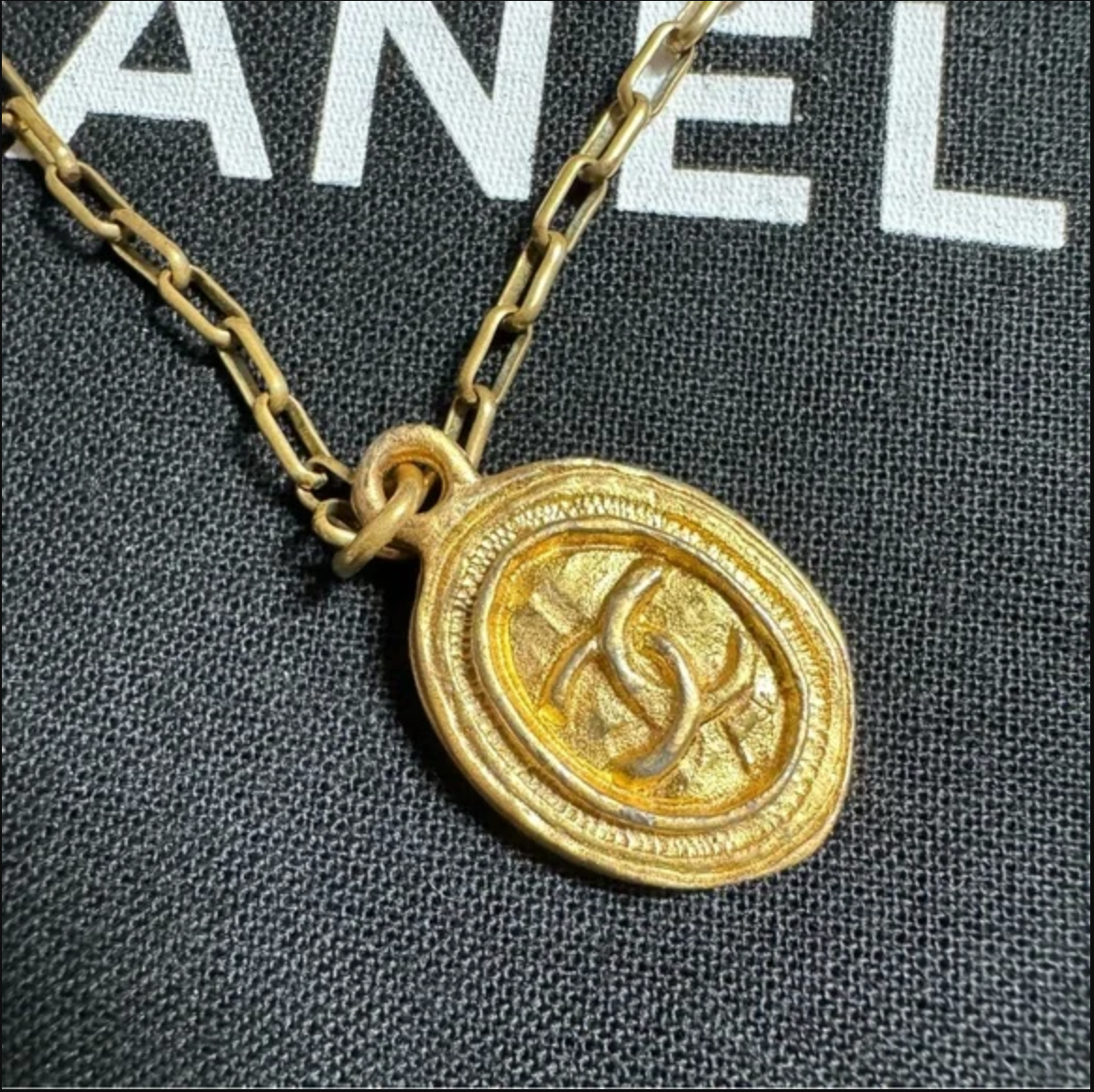 CHANEL gold toned CC logo charm and necklace