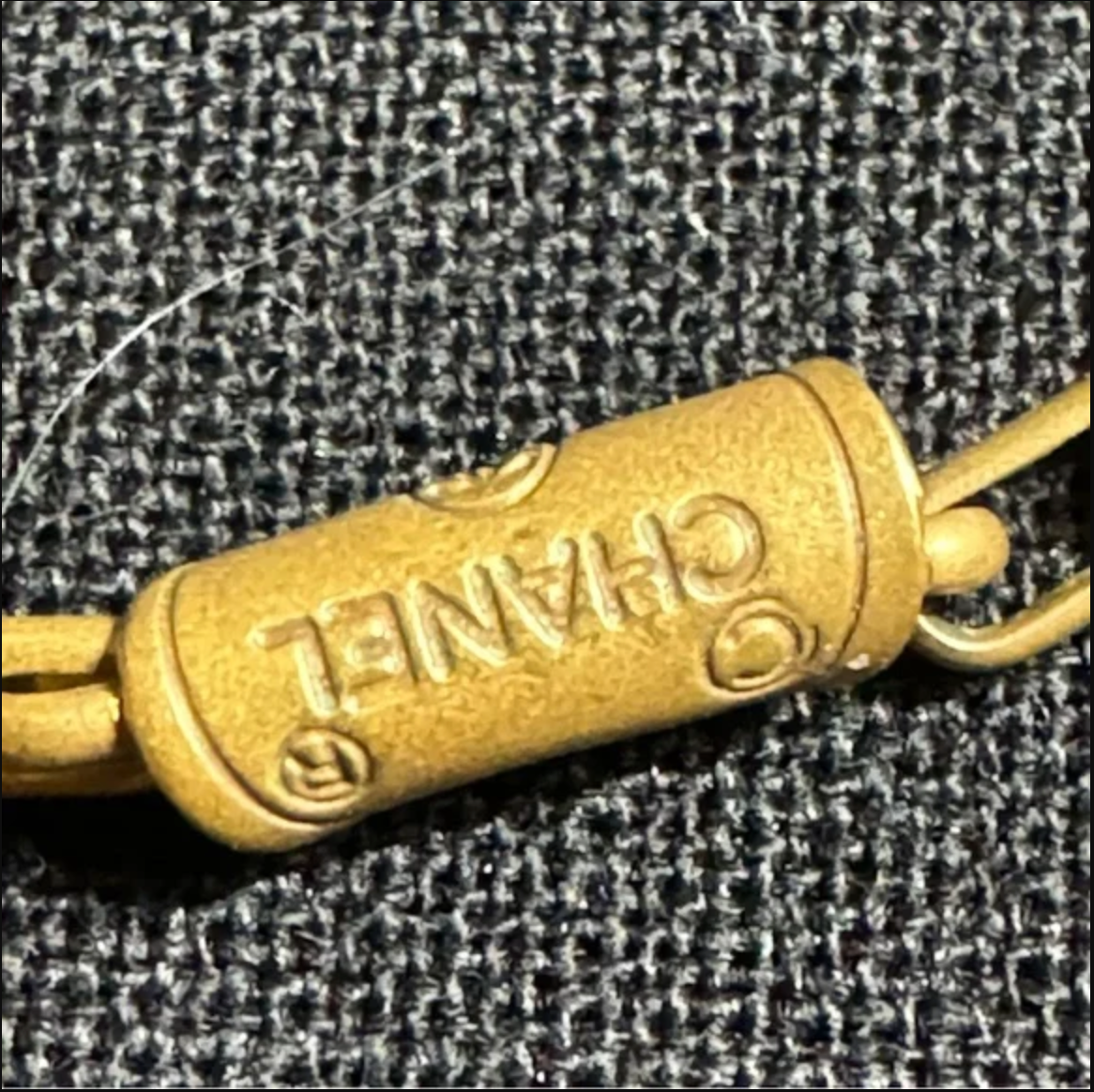 CHANEL gold toned CC logo charm and necklace