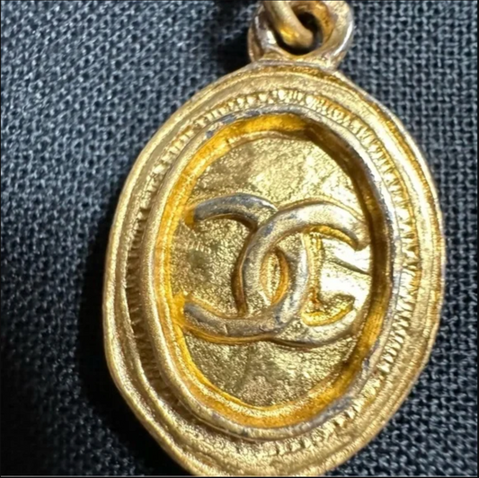 CHANEL gold toned CC logo charm and necklace