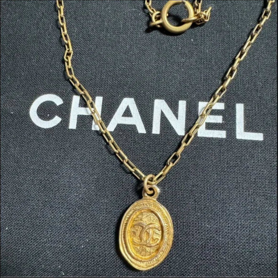 CHANEL gold toned CC logo charm and necklace