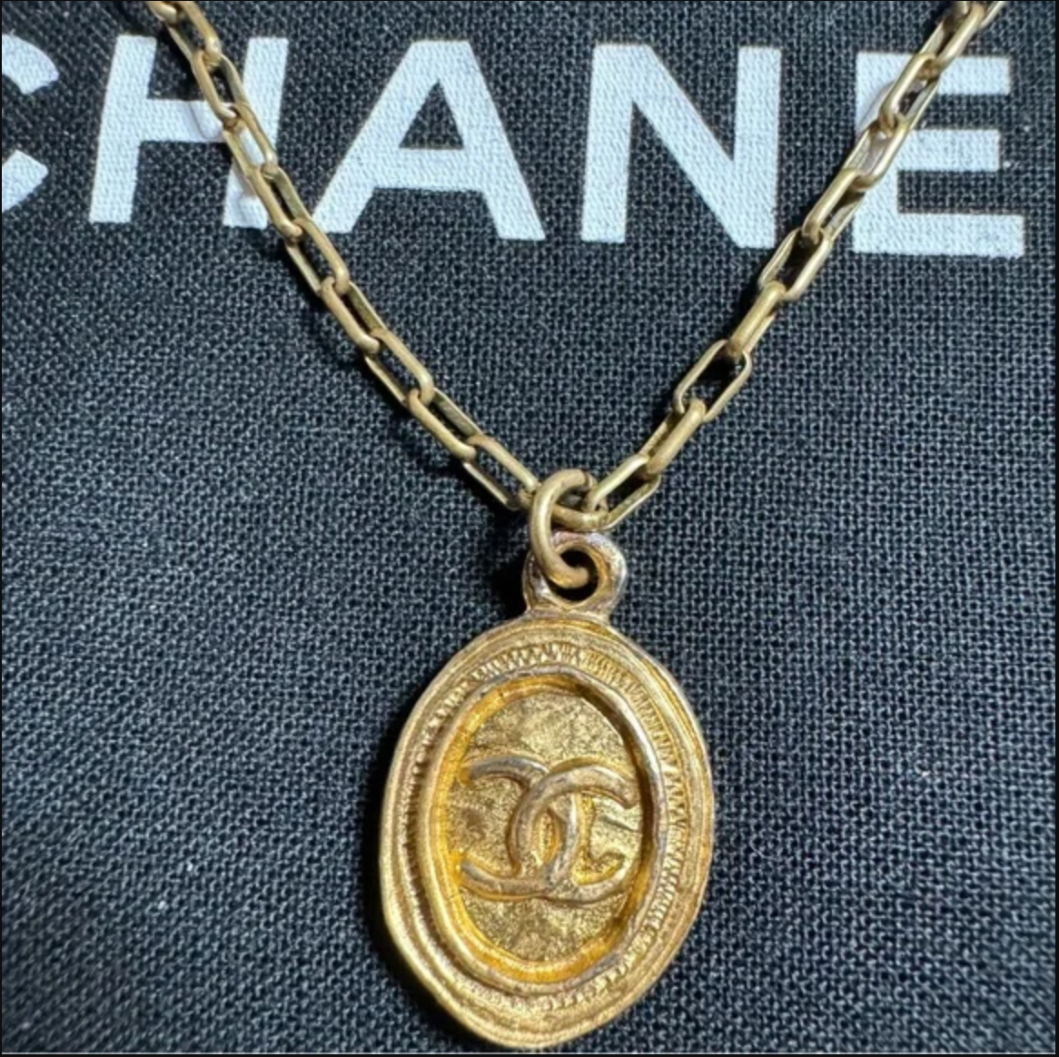 CHANEL gold toned CC logo charm and necklace
