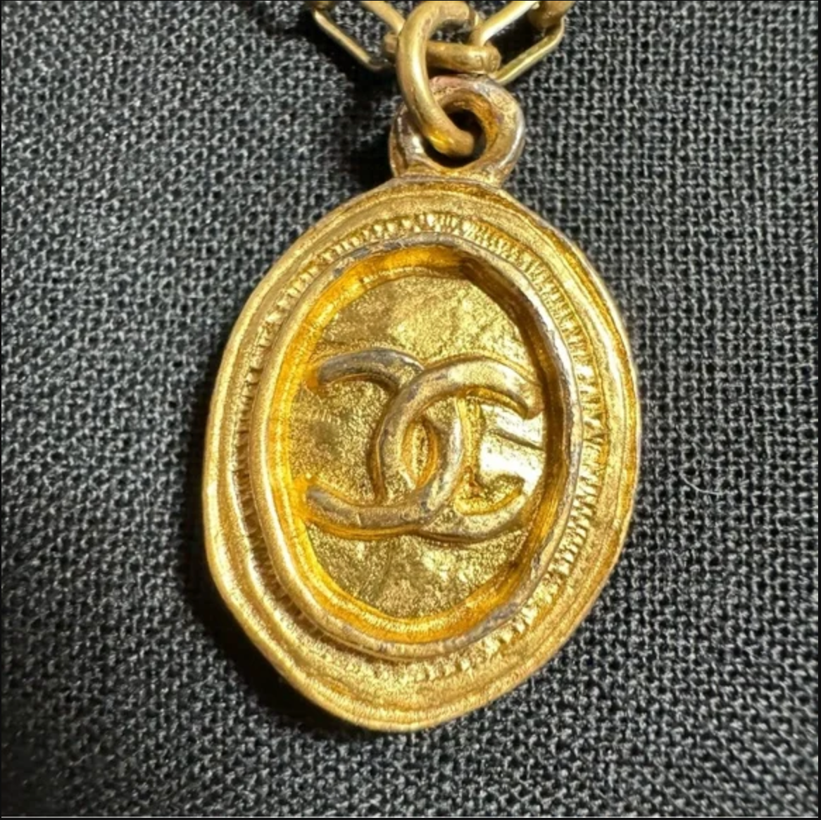 CHANEL gold toned CC logo charm and necklace