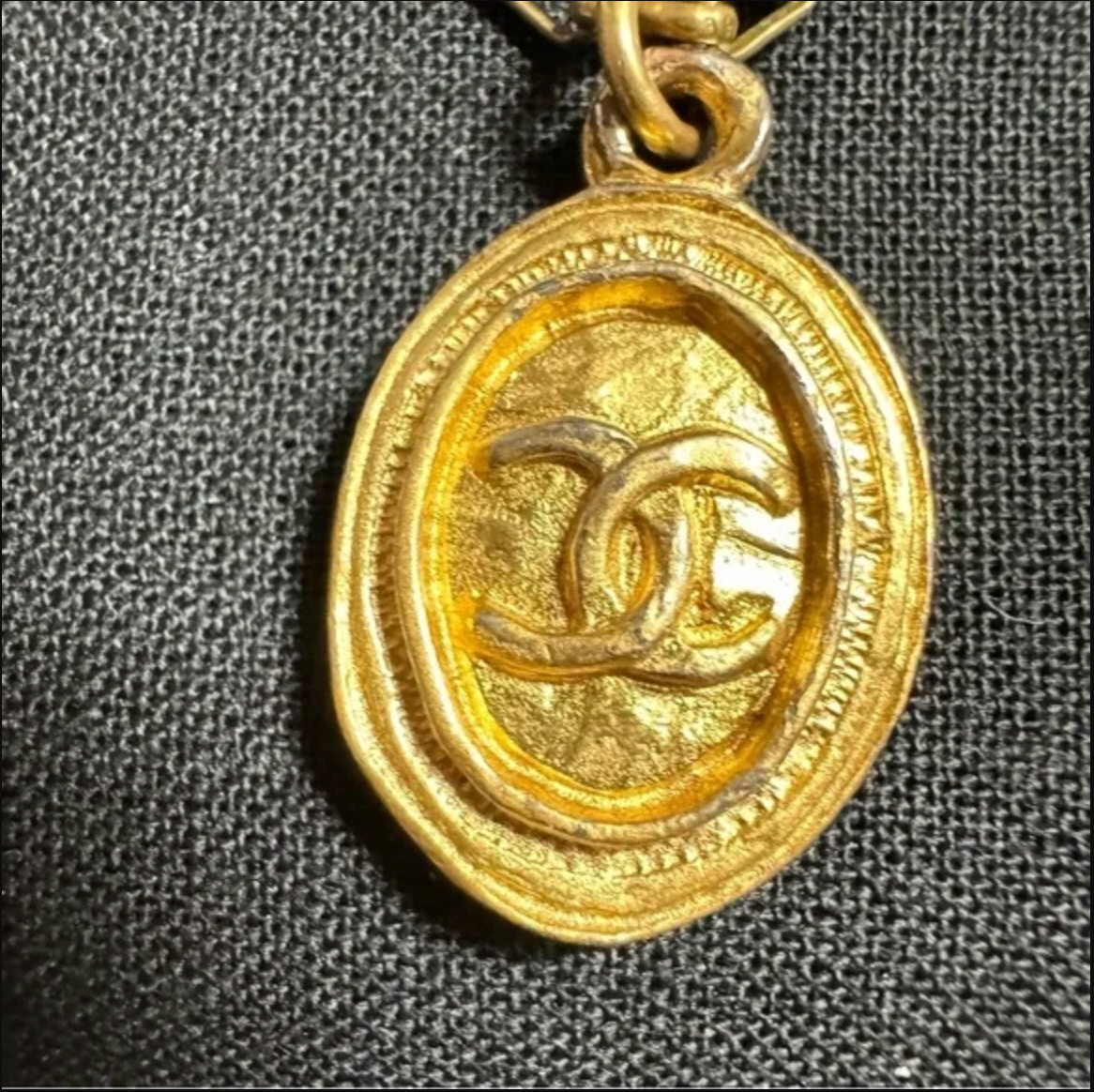 CHANEL gold toned CC logo charm and necklace
